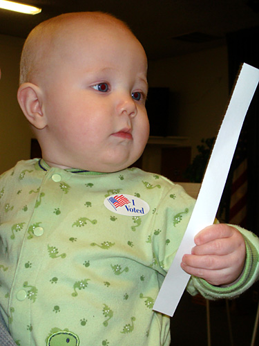 James holding the paper receipt after voting